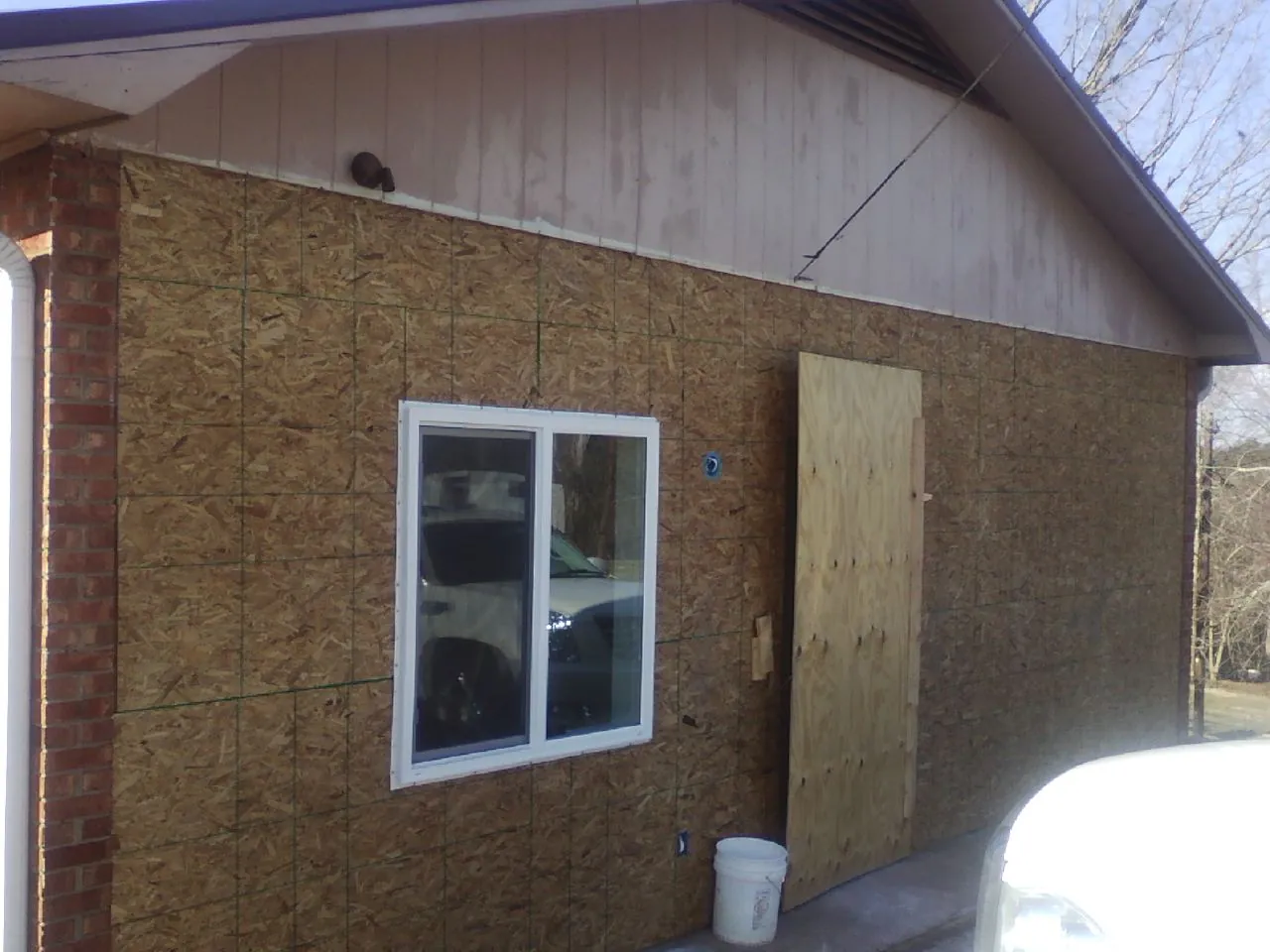 OSB sheathing on a garage addition wall before siding in Julian